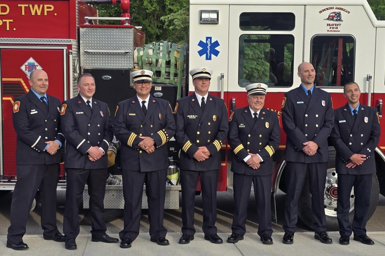 The department's officers in dress uniform in front of Station 3 apparatus