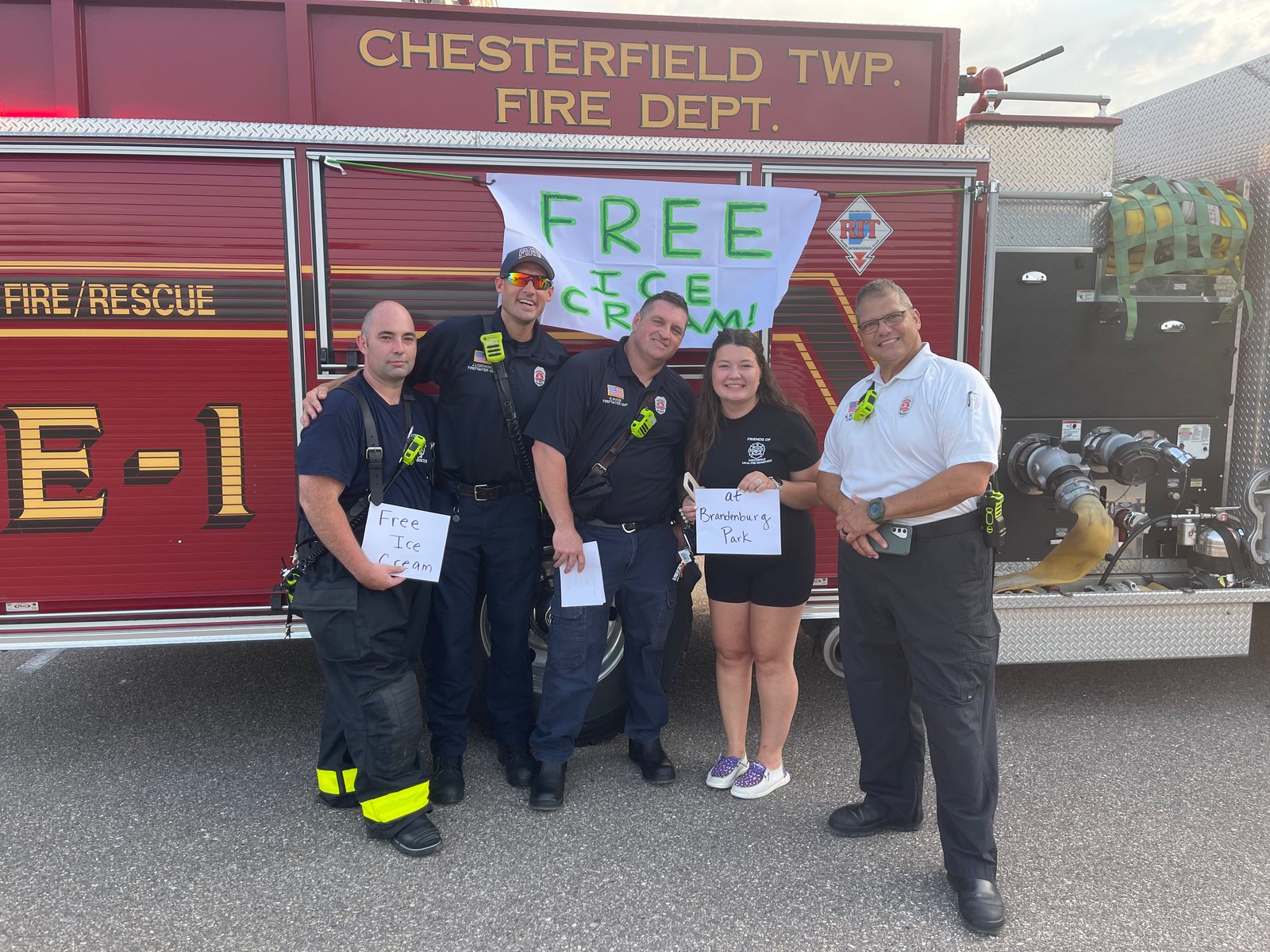 Firefighters and Friends volunteers at a free ice cream giveaway in front of Engine 1