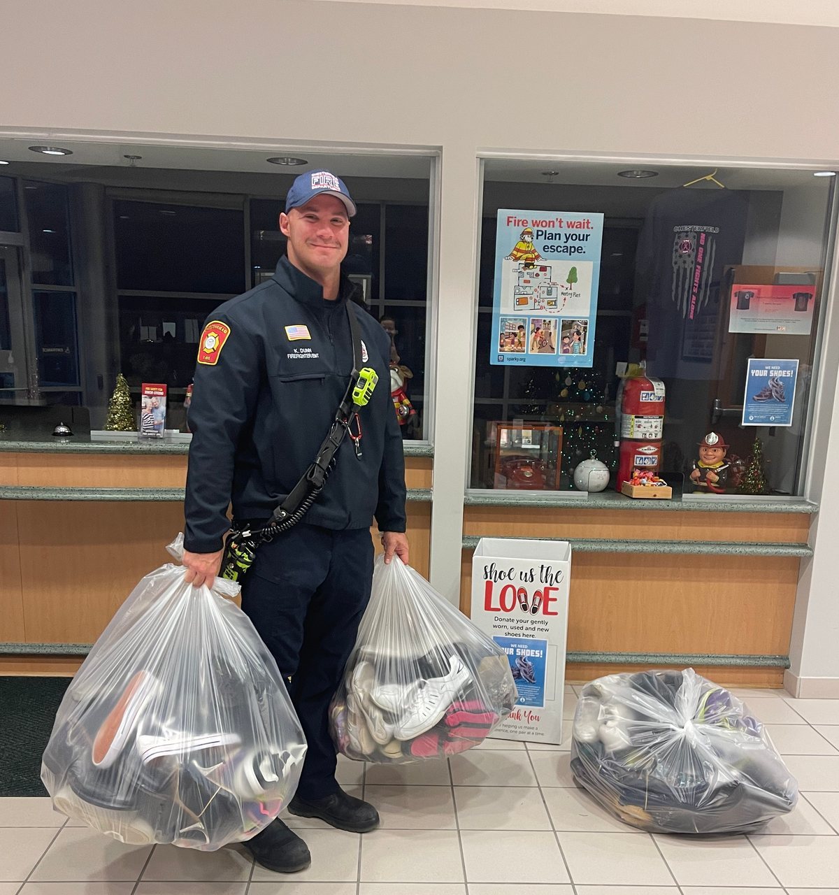 A Chesterfield firefighter carrying bags of donated shoes in the Fire Station 3 lobby