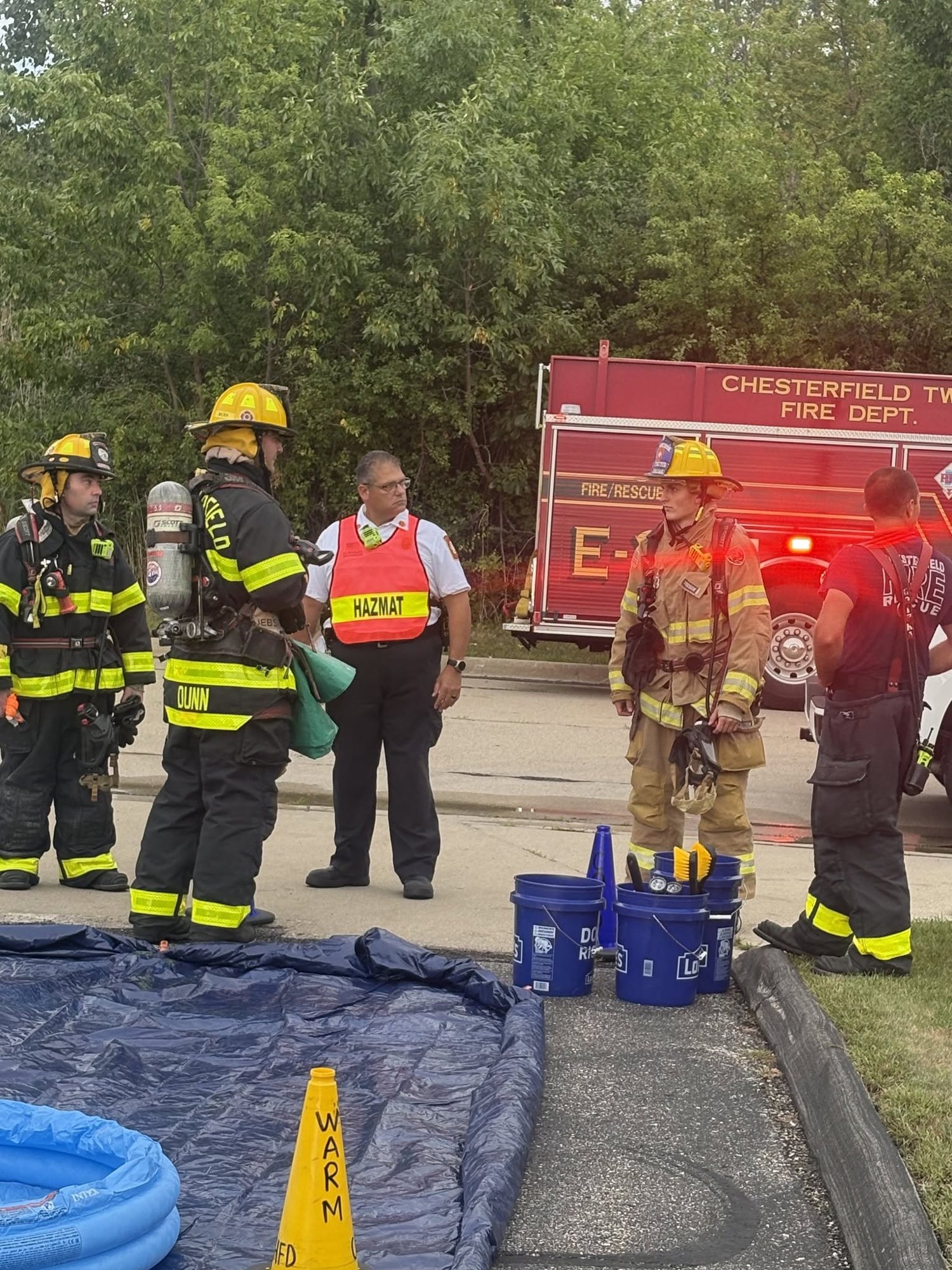 Firefighters in SCBA setting up a containment area during hazardous materials training