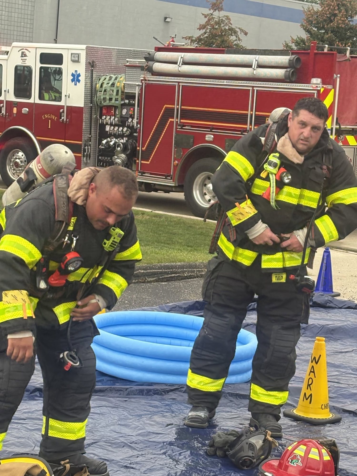 Firefighters in turnout gear and SCBA working a hazardous materials drill