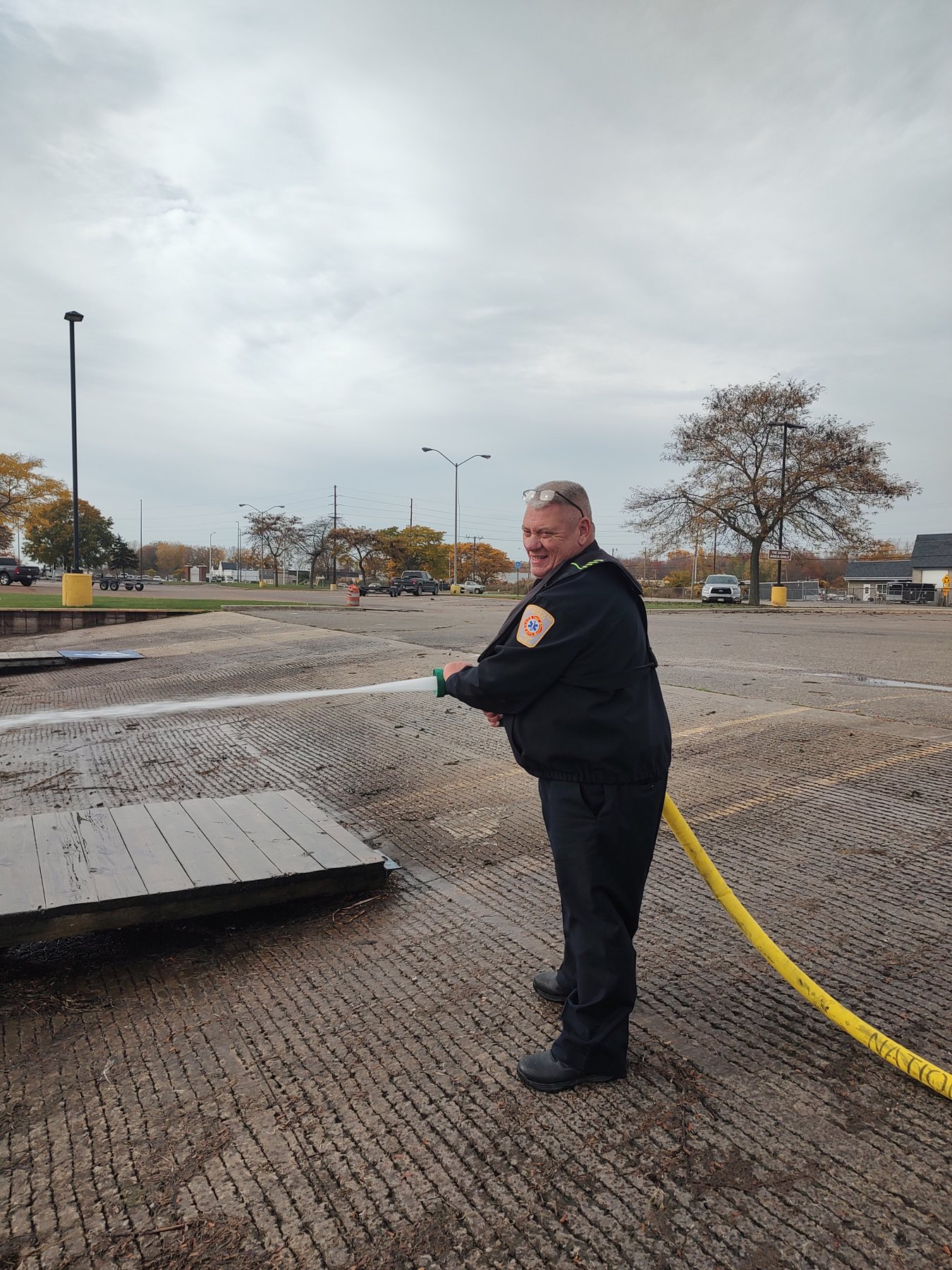 A firefighter flowing a hose line at a boat launch