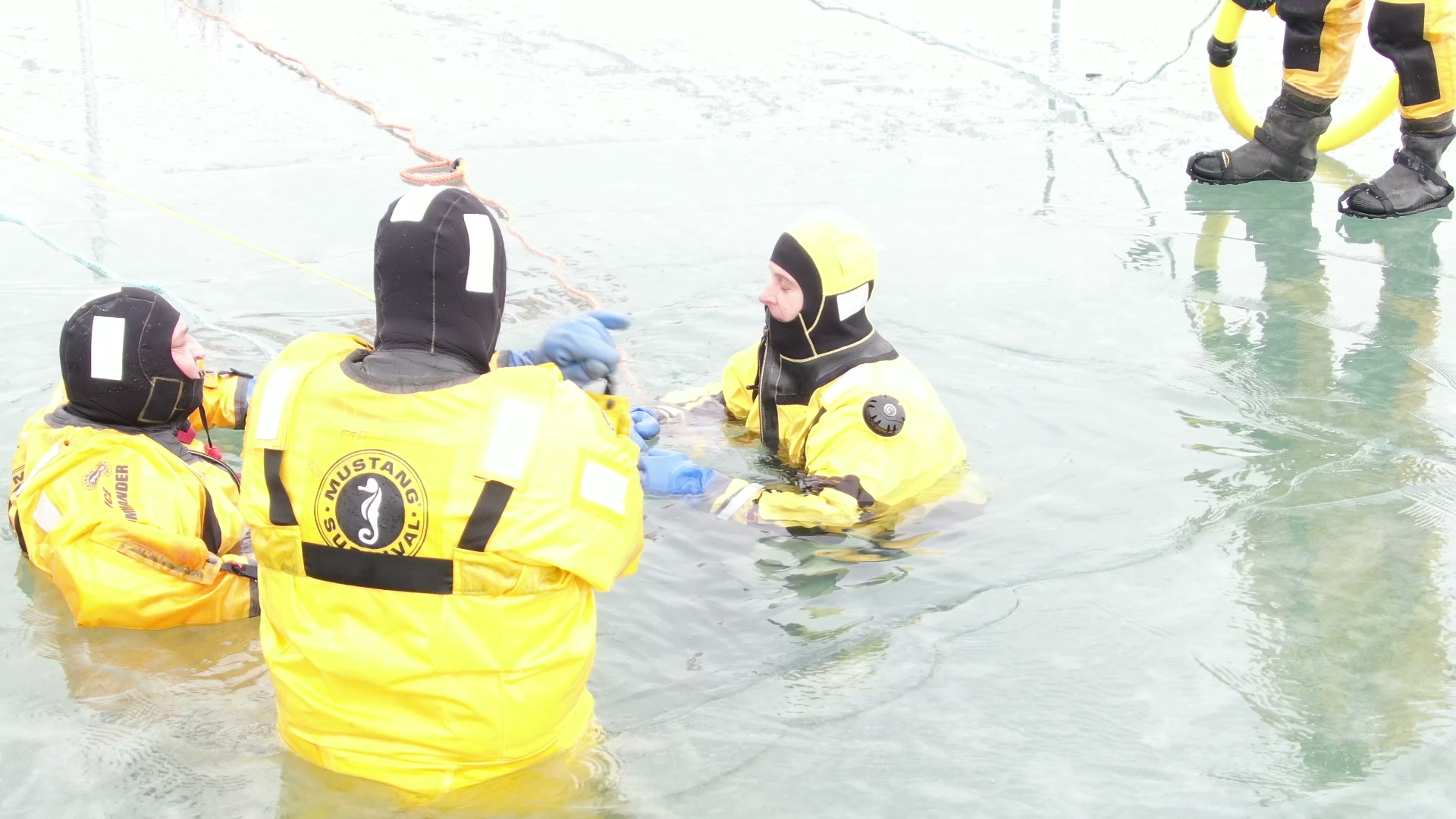Ice rescue technicians in the water during a drill