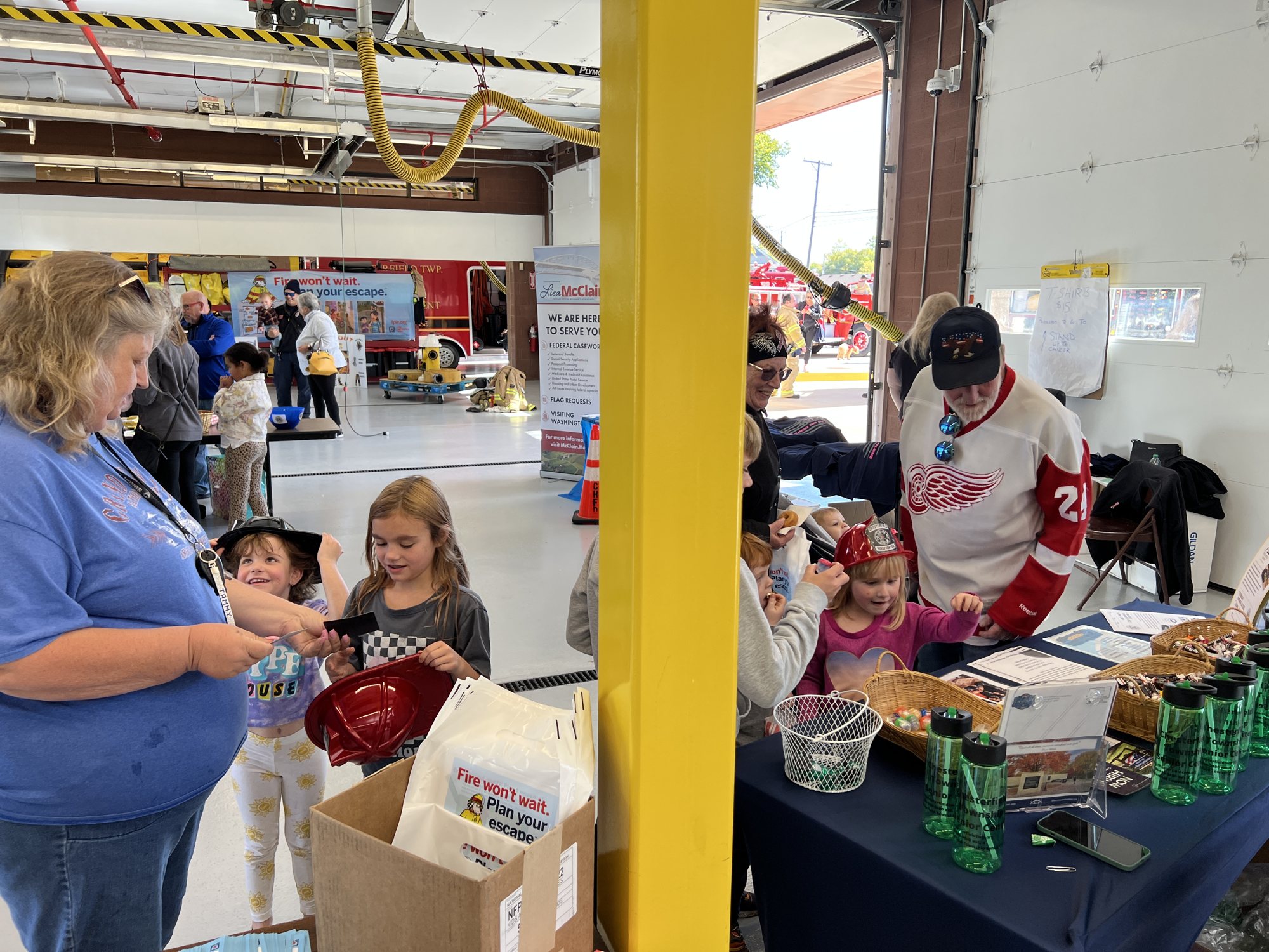 Children at a community booth in the apparatus bay