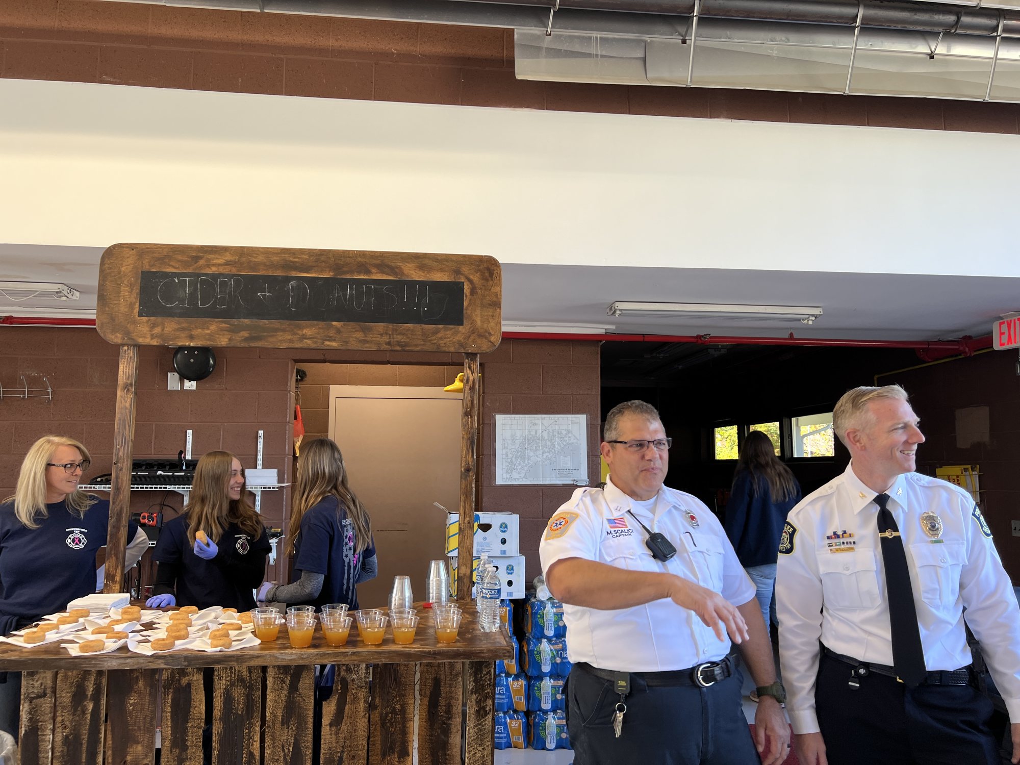 Firefighters serving refreshments at the cider and donut stand