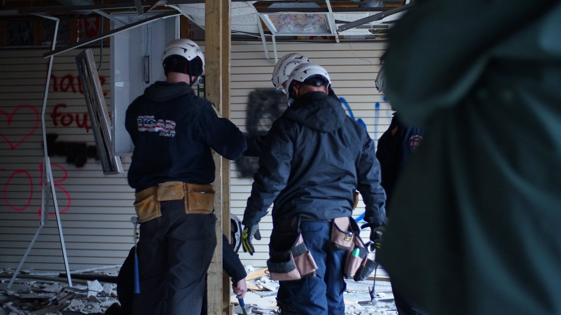 Rescuers at a building collapse training site