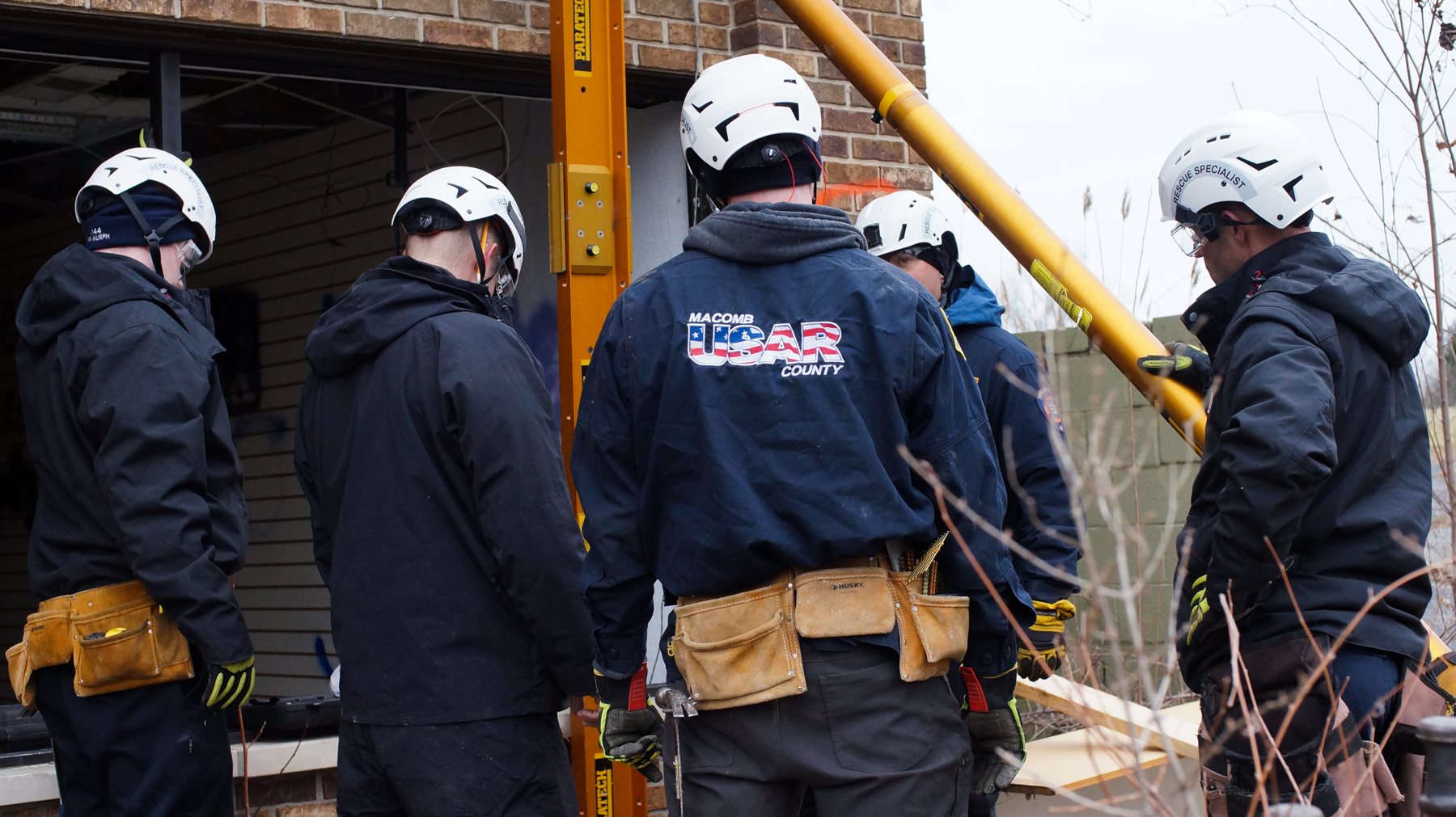 Rescuers placing shoring at a building collapse training site