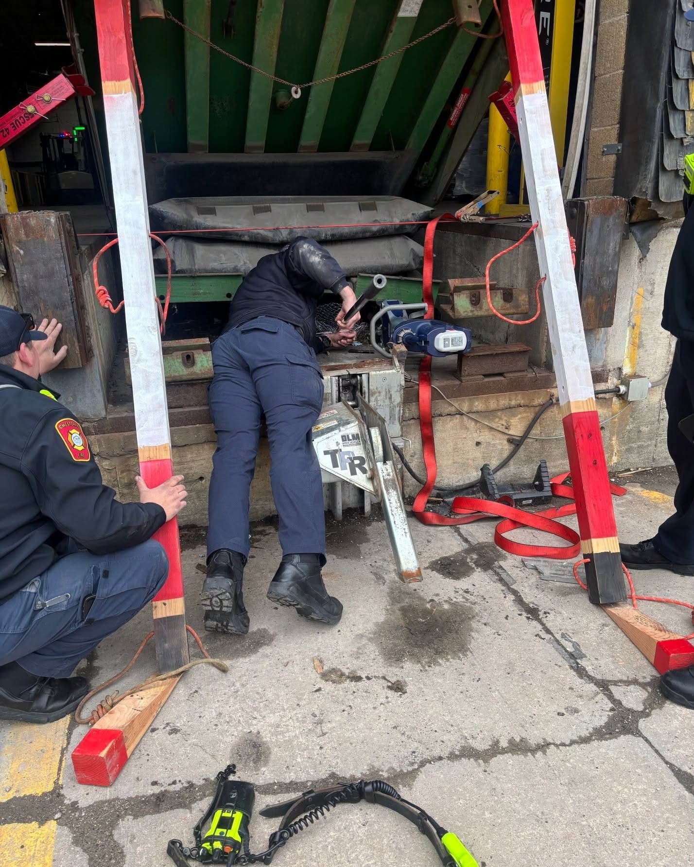 Firefighters working beneath a stabilized load during heavy rescue training