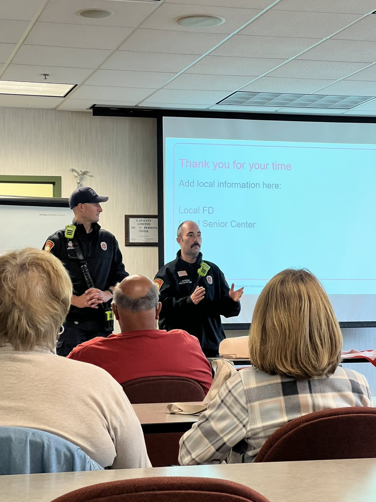Firefighters teaching a senior first aid class