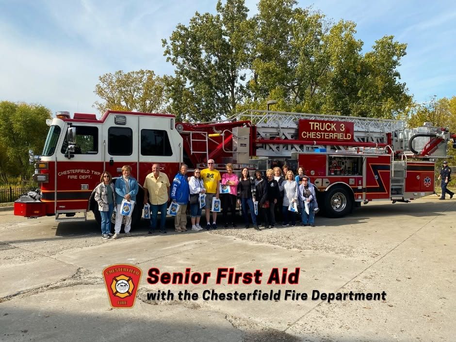 Seniors with Chesterfield firefighters in front of Truck 3 after a first aid class