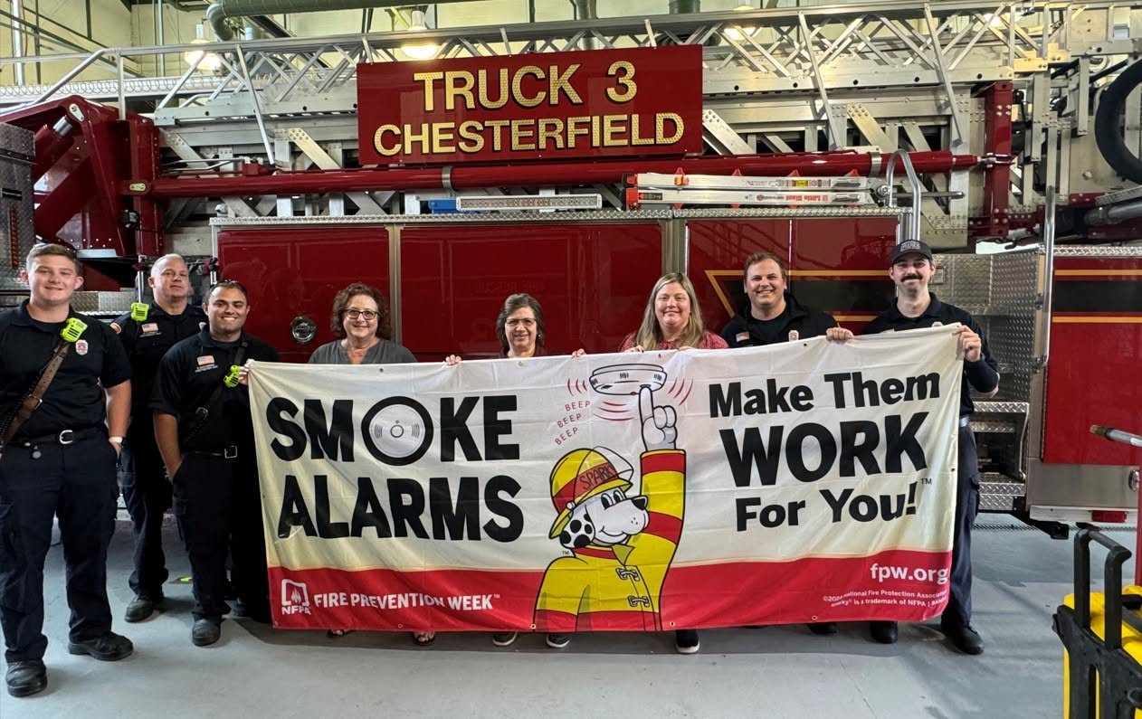 Firefighters with the Smoke Alarms: Make Them Work for You banner in front of Truck 3