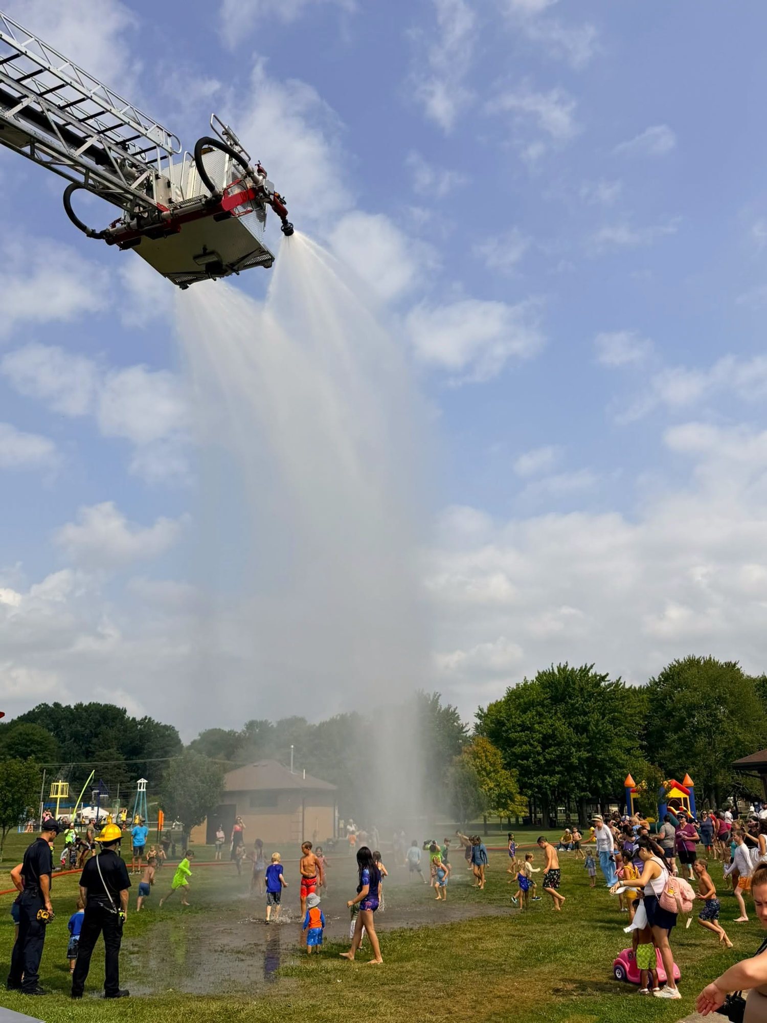 Truck 3's aerial spraying water over children at a summer splash day