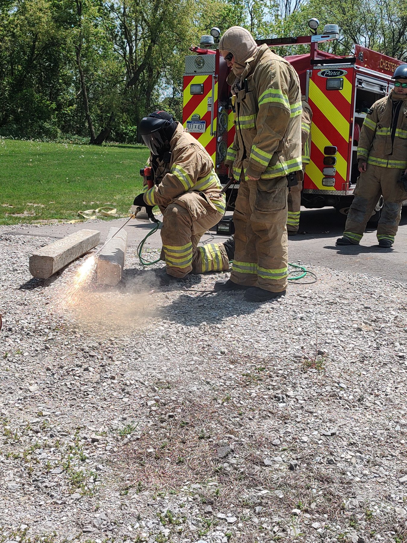 Firefighters cutting with a rescue saw during hands-on training