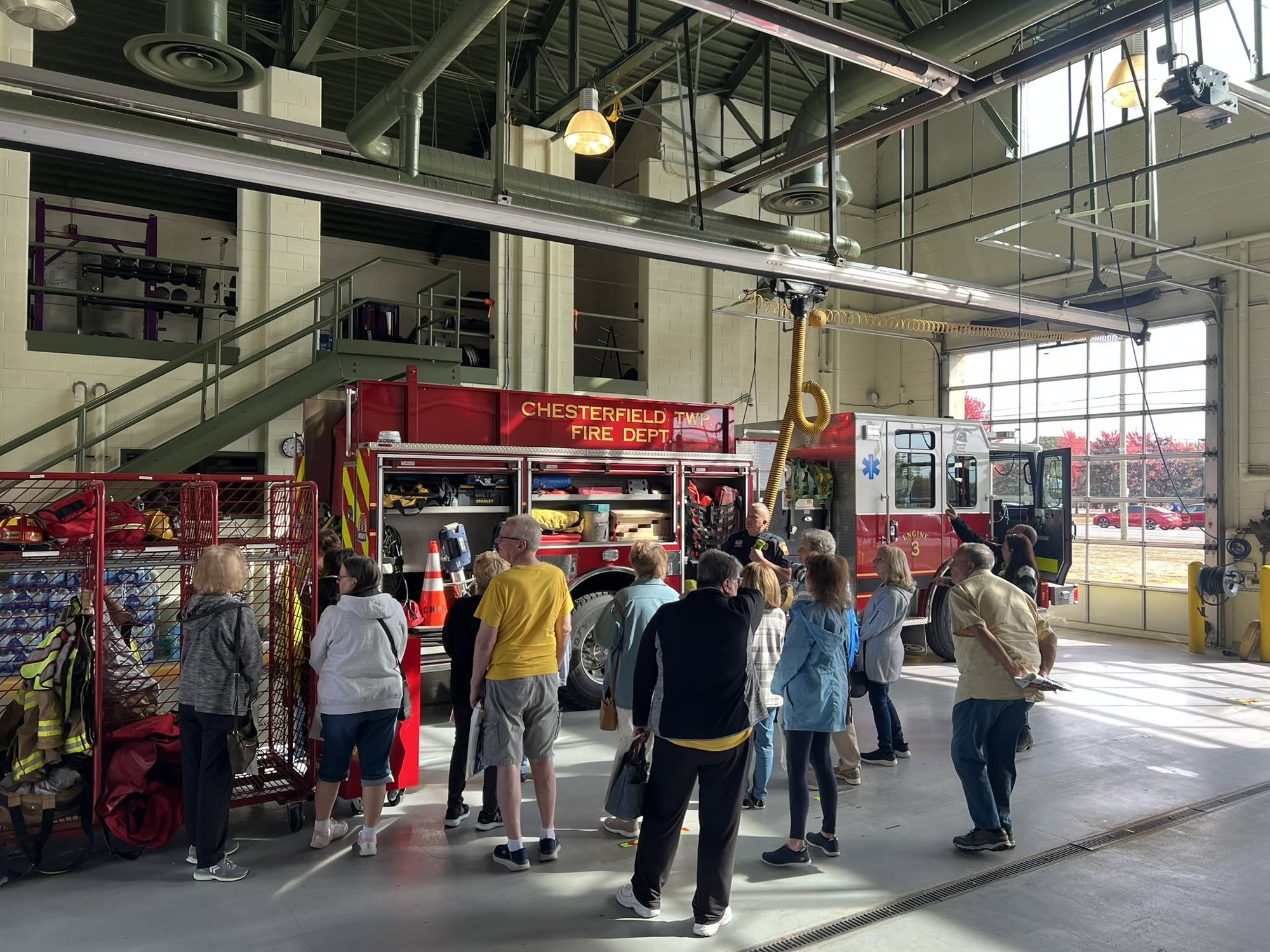 Visitors touring the apparatus bay with firefighters