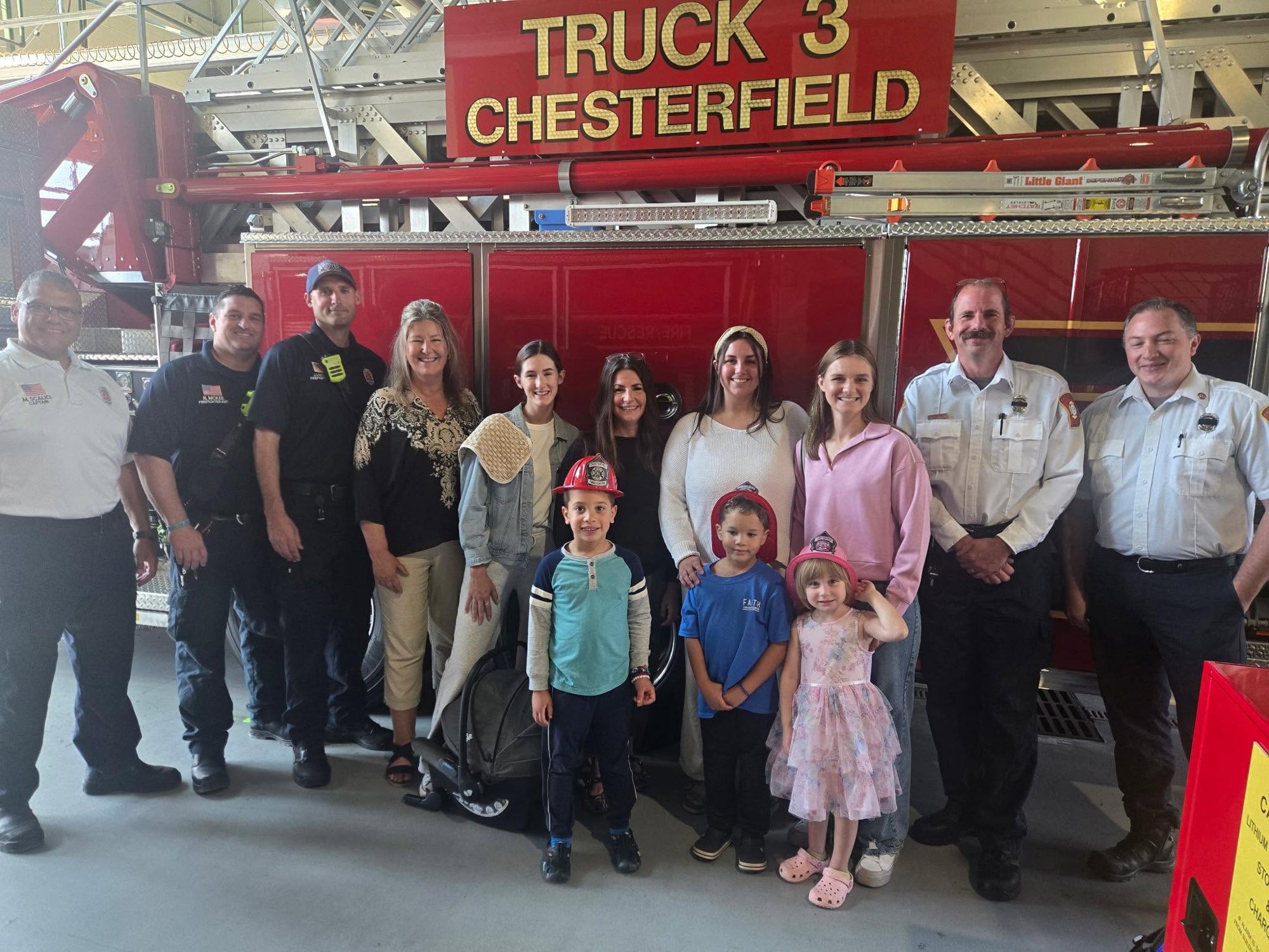 Families and children visiting Chesterfield firefighters in front of Truck 3