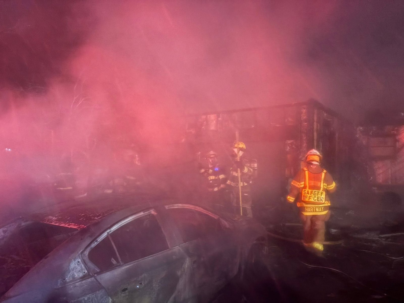 Firefighters working in heavy smoke at the Hagen Road fire