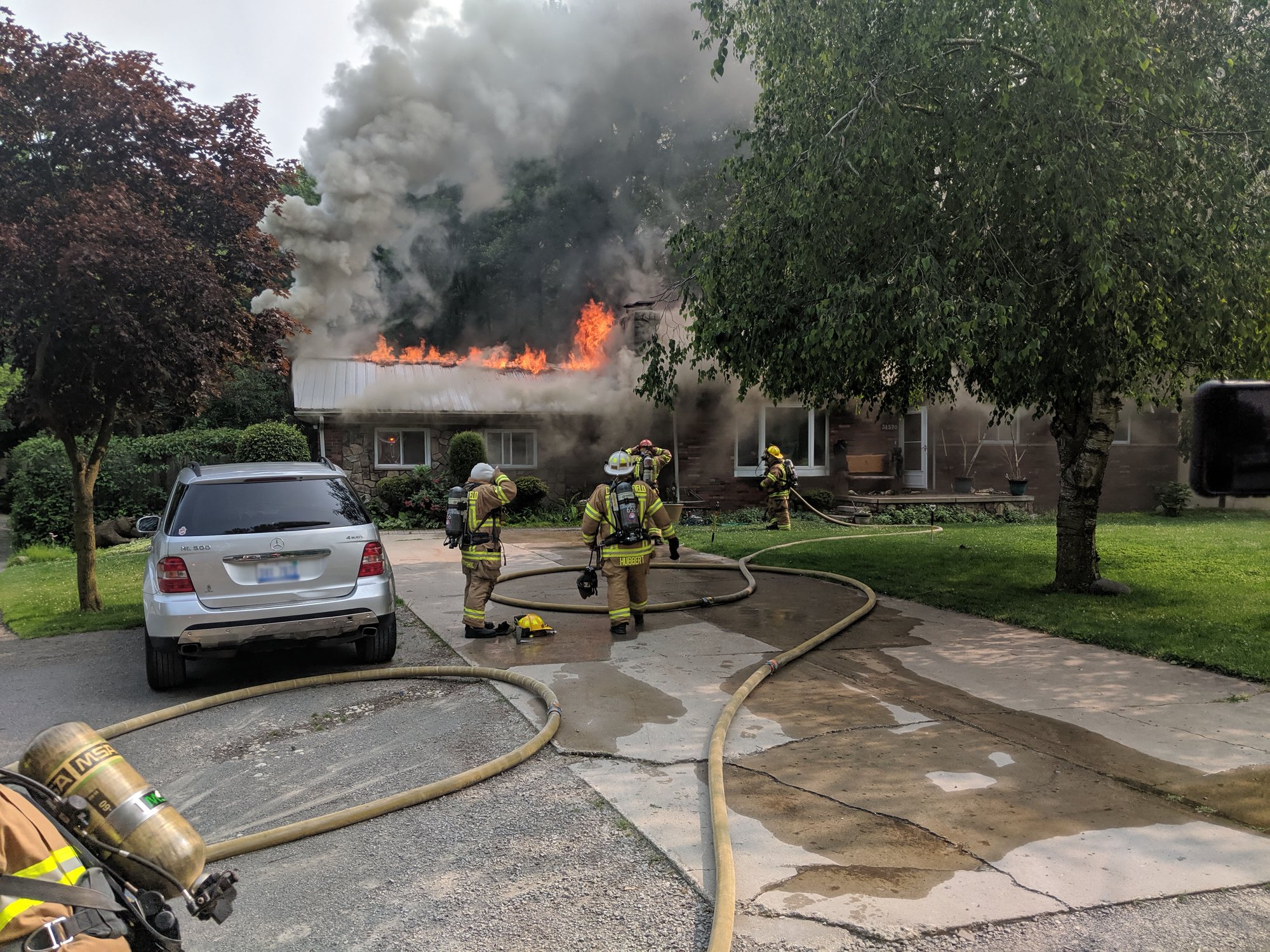 Chesterfield firefighters with hose lines at a house fire