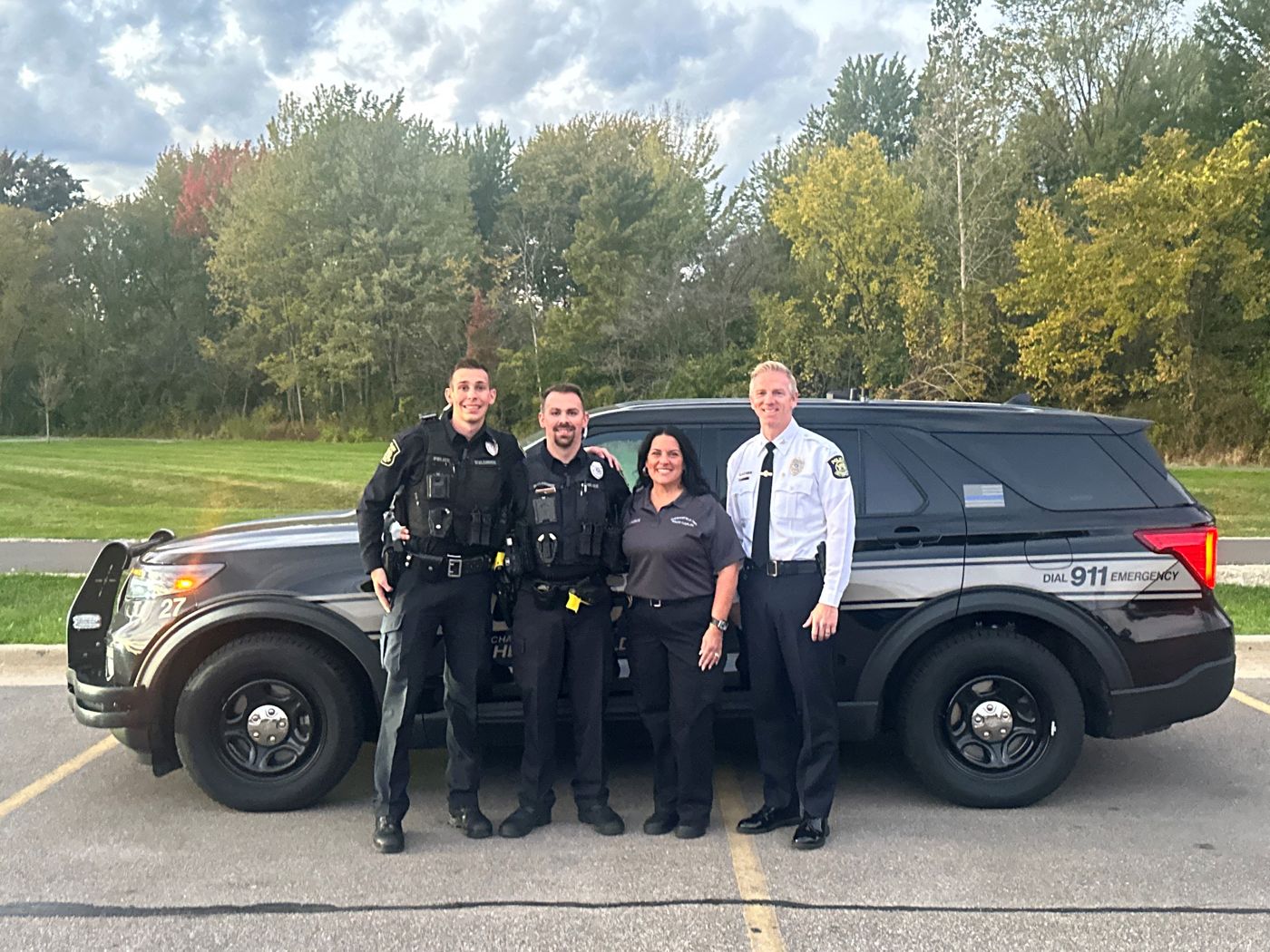 Chaplain Kim Fleece with Director Brian Bassett and officers in 2024